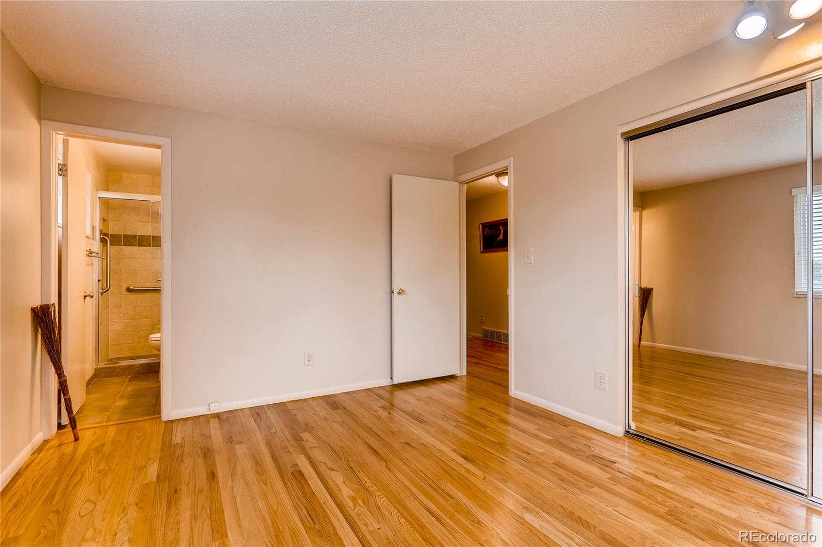 1458 South Oneida Street Denver, CO 80224 - Photo 15 of 33 a view of an empty room with wooden floor and a window