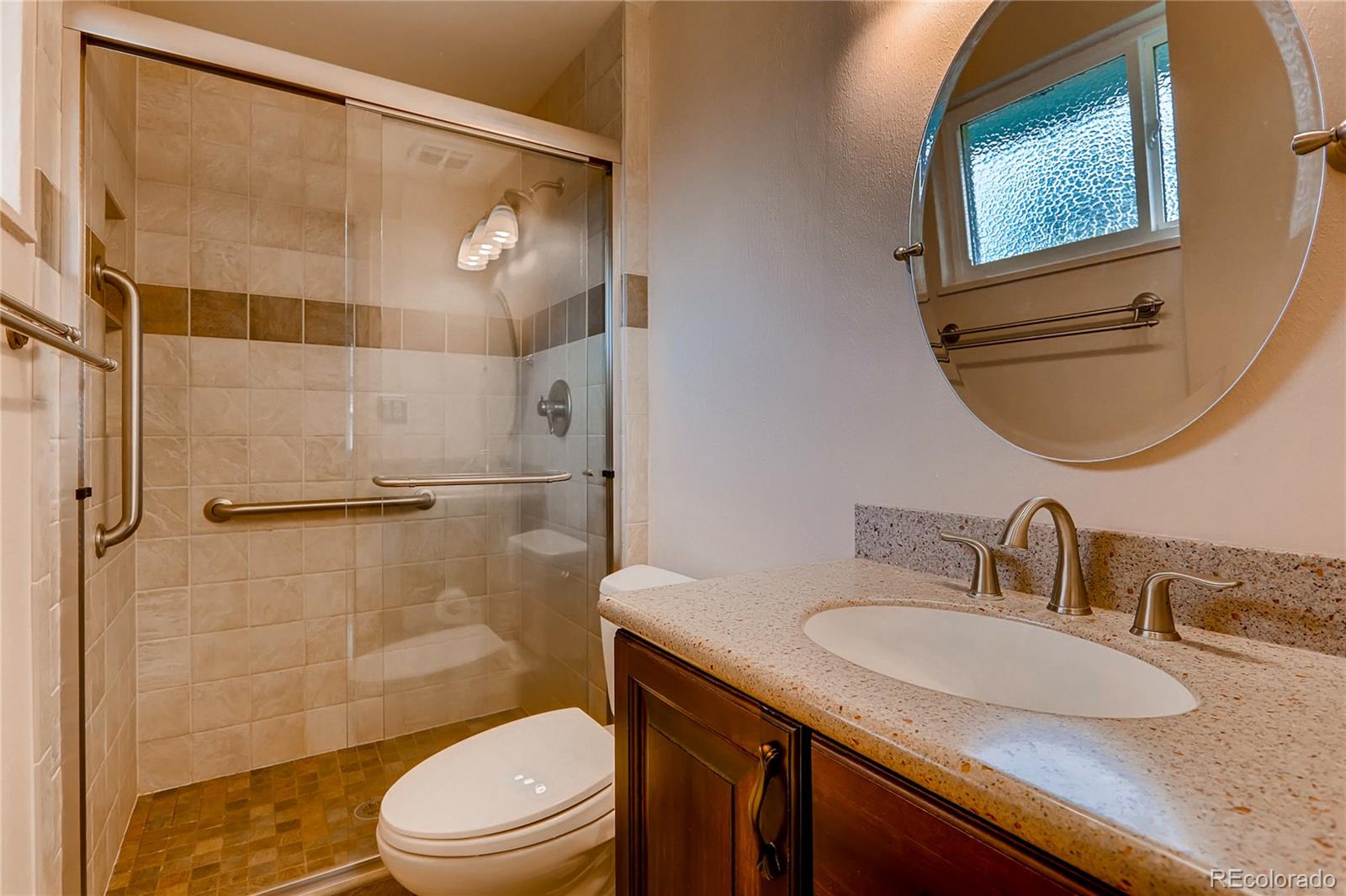 1458 South Oneida Street Denver, CO 80224 - Photo 16 of 33 a bathroom with a granite countertop sink toilet and shower