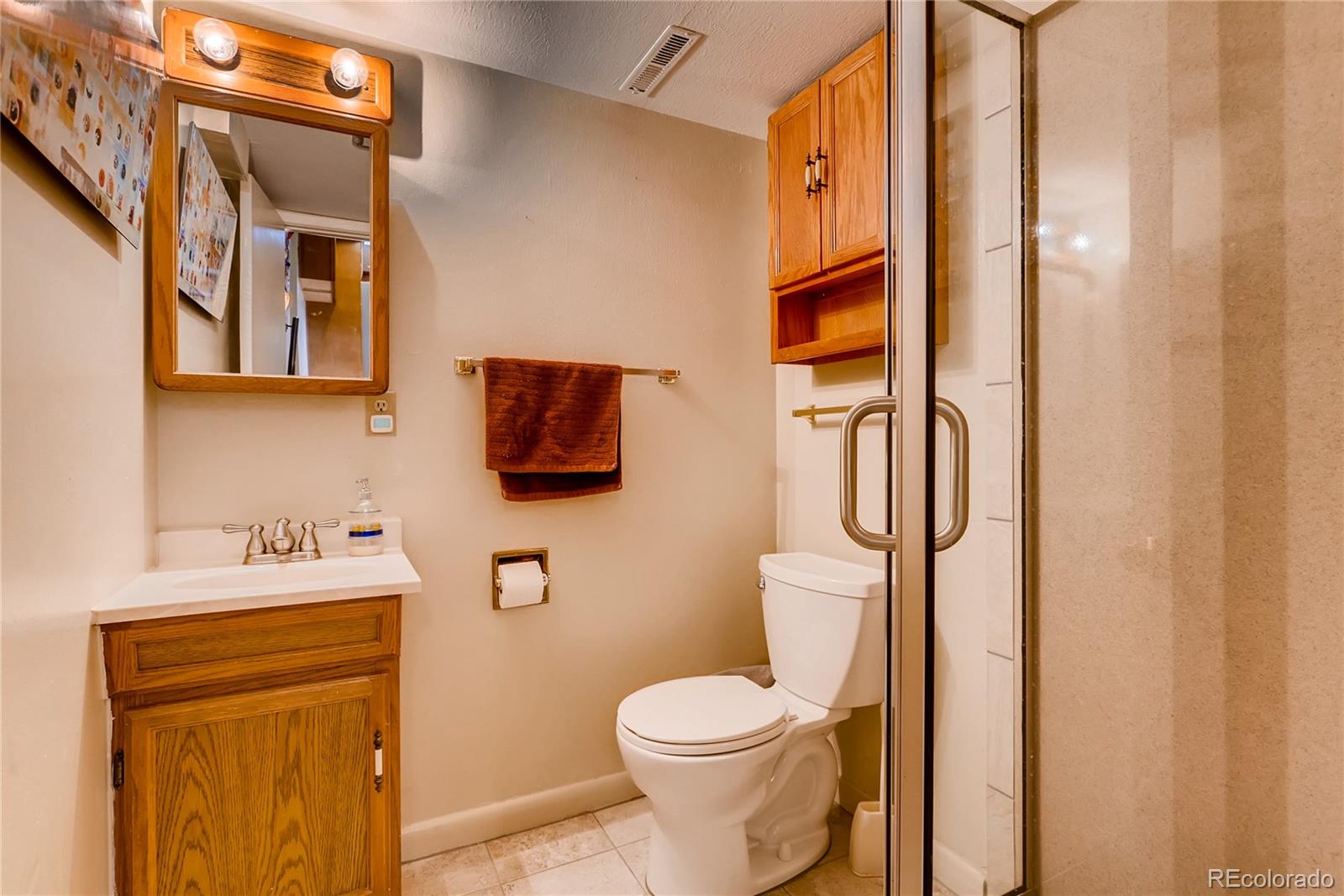 1458 South Oneida Street Denver, CO 80224 - Photo 19 of 33 a bathroom with a toilet sink and mirror