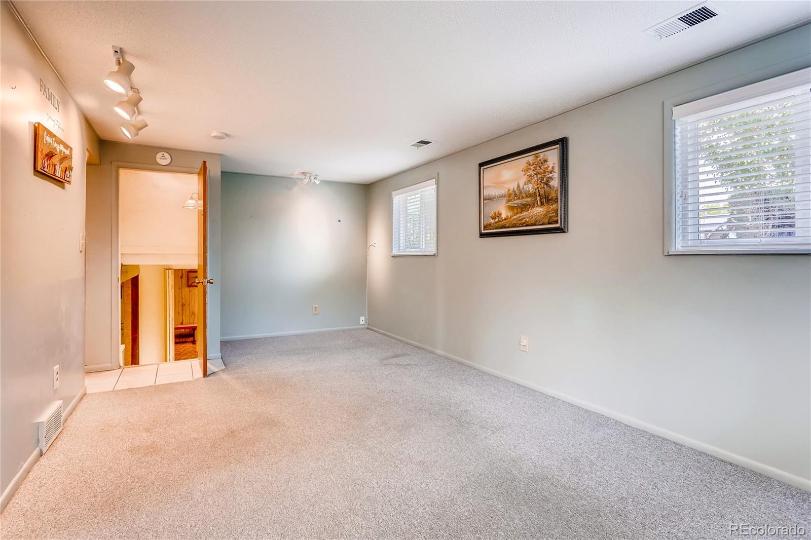 1458 South Oneida Street Denver, CO 80224 - Photo 23 of 33 an empty room with windows and closet