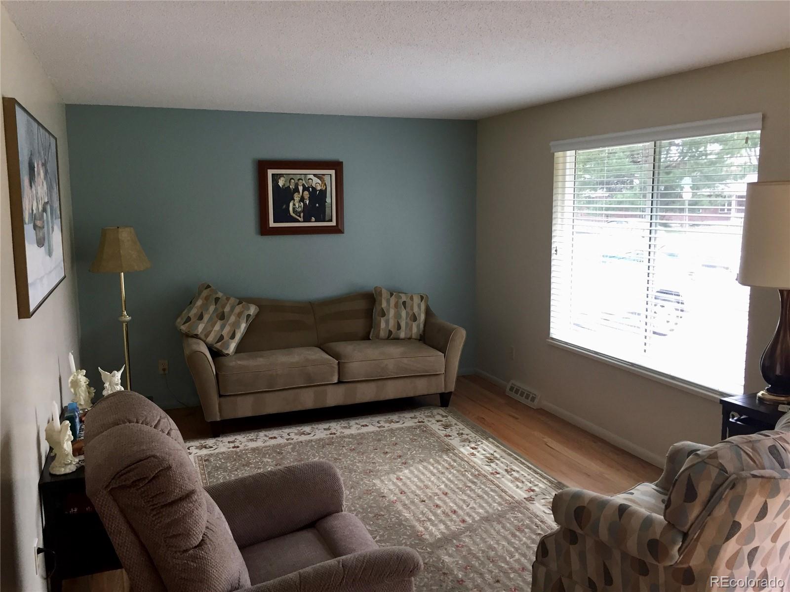 1458 South Oneida Street Denver, CO 80224 - Photo 6 of 33 a living room with furniture and a window