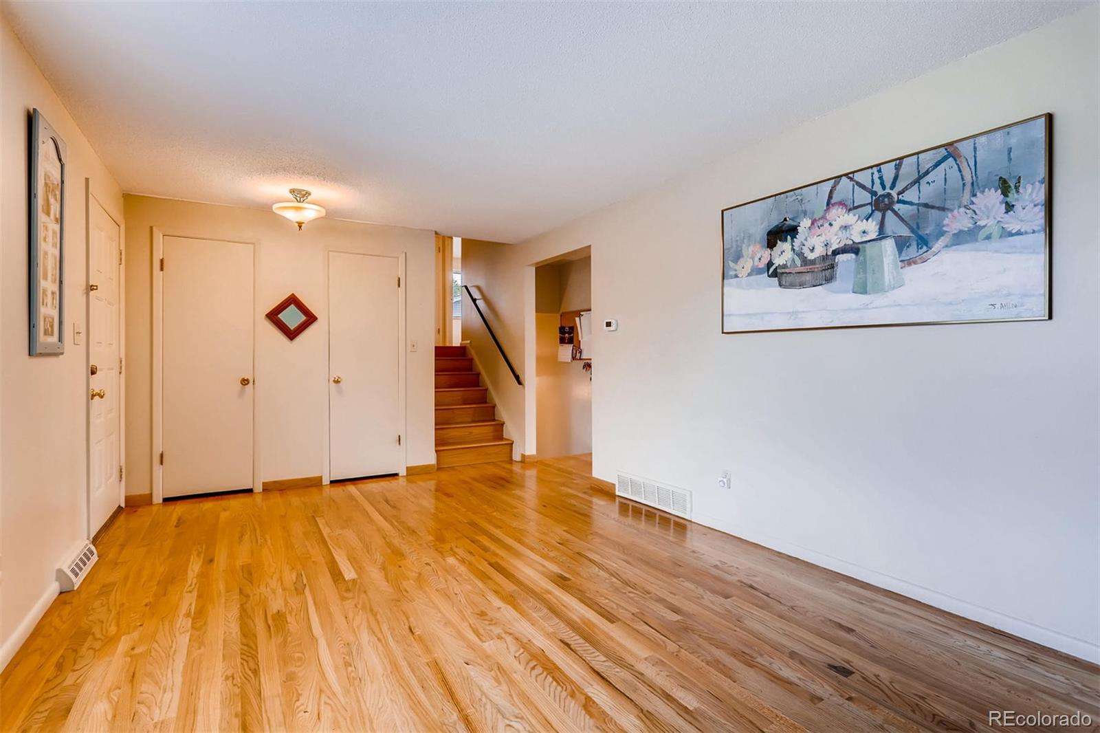 1458 South Oneida Street Denver, CO 80224 - Photo 8 of 33 a view of a hallway with wooden floor