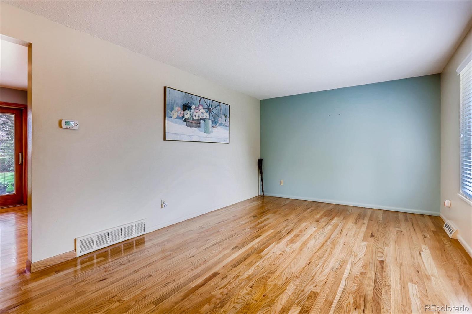 1458 South Oneida Street Denver, CO 80224 - Photo 9 of 33 a view of empty room with wooden floor