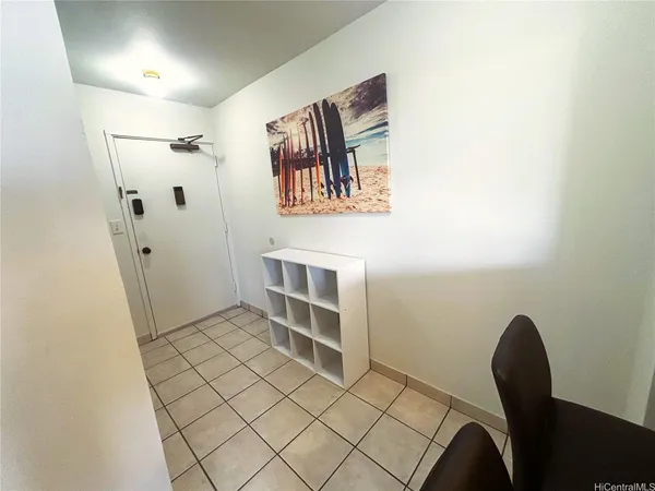 a view of a hallway with furniture and entryway