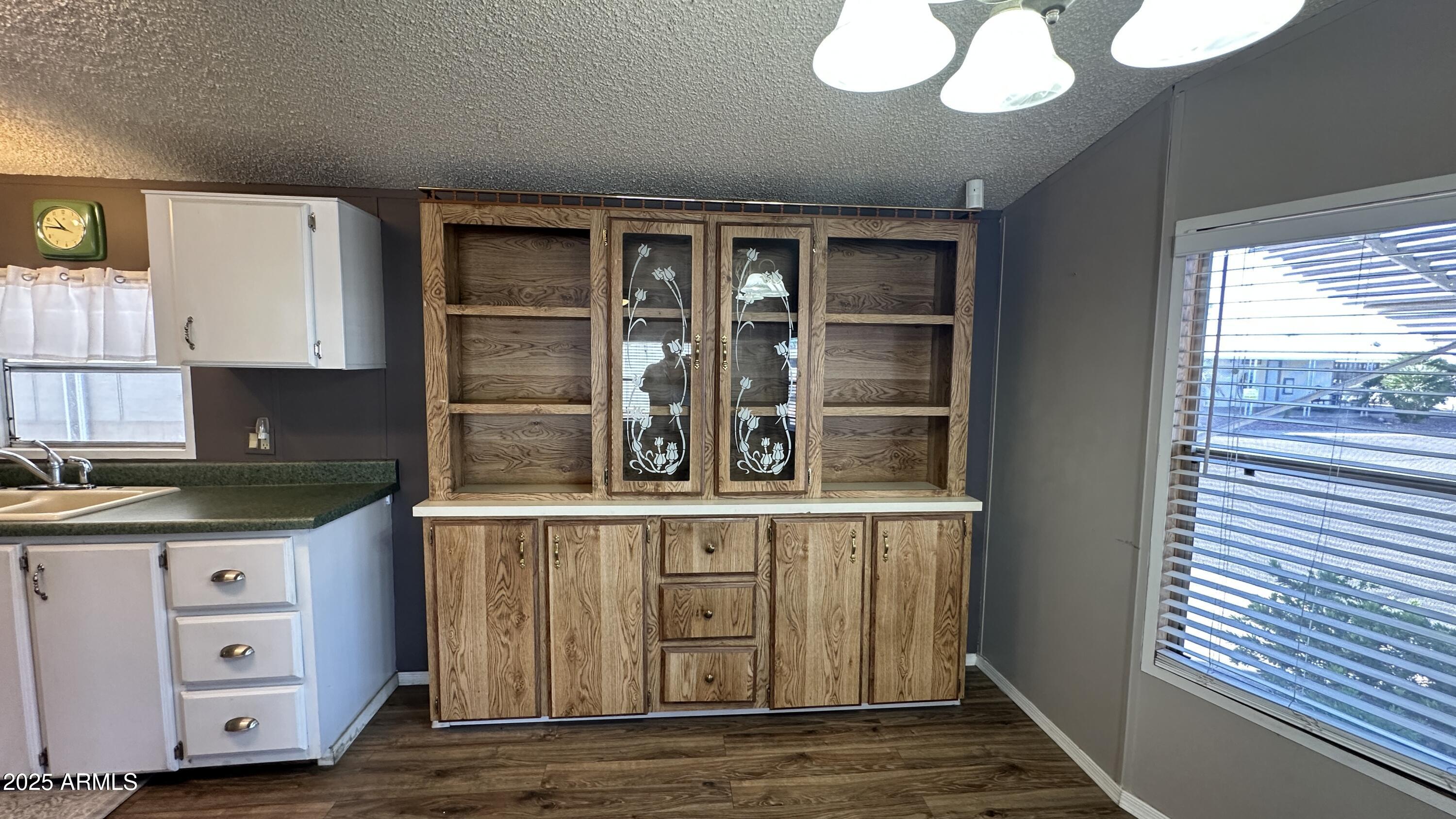 834 South Meridian Road, Unit 105 Apache Junction, AZ 85120 - Photo 9 of 48 a kitchen with stainless steel appliances granite countertop a sink and cabinets with wooden floor