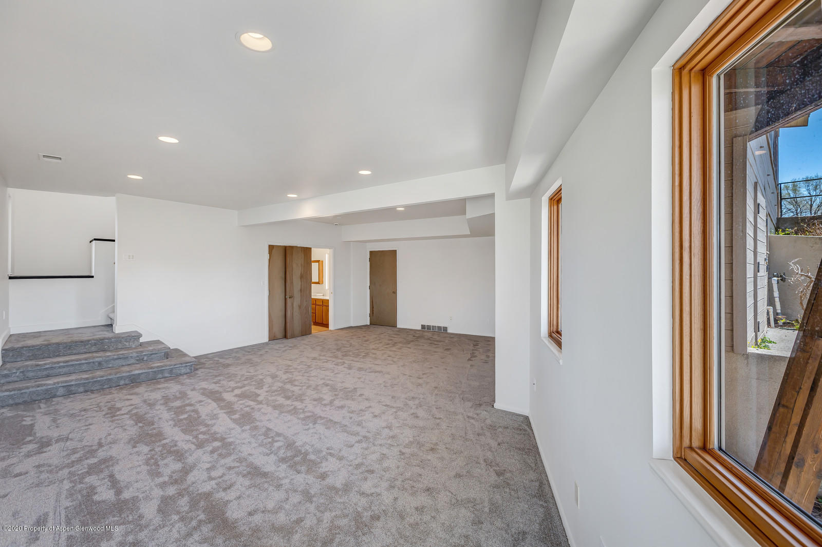 735 Ute Avenue Rifle, CO 81650 - Photo 18 of 30 a view of empty room with a fireplace and wooden floor