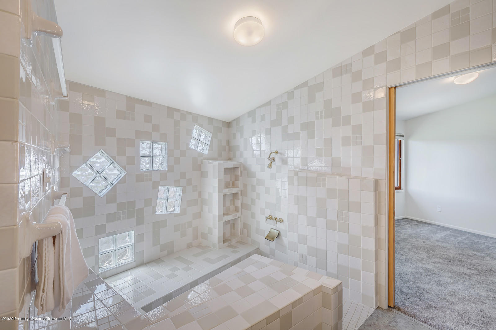 735 Ute Avenue Rifle, CO 81650 - Photo 22 of 30 a bathroom with a granite countertop shower a mirror and a sink