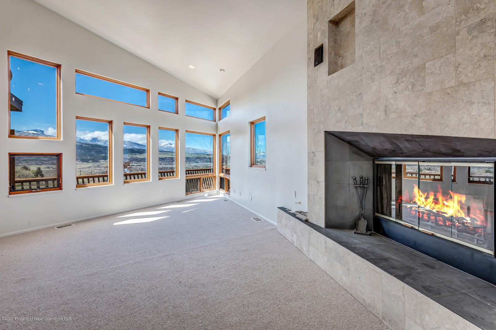 735 Ute Avenue Rifle, CO 81650 - Photo 5 of 30 a view of an empty room with a fireplace and a window