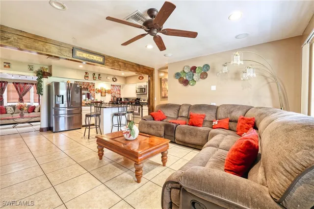a living room with furniture and kitchen view