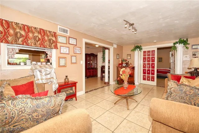 a living room with furniture and floor to ceiling window