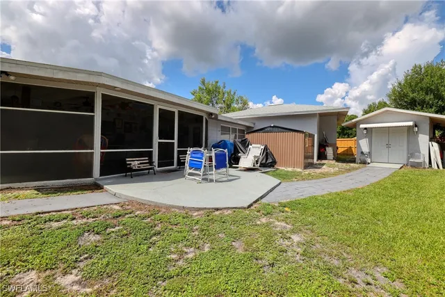 a swimming pool with outdoor seating yard and barbeque oven
