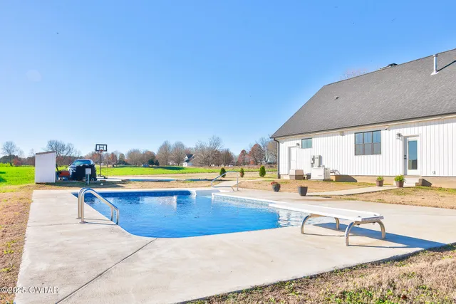 a view of a swimming pool and a lounge chair