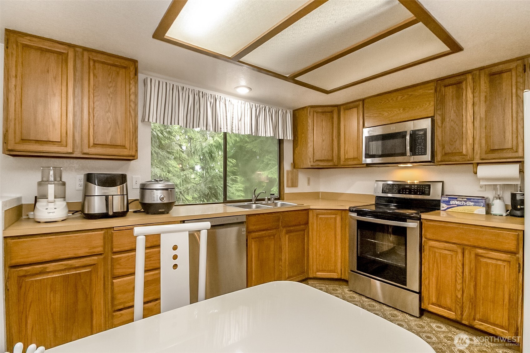22121 4th Avenue Southeast Bothell, WA 98021 - Photo 4 of 22 a kitchen with stainless steel appliances granite countertop a stove sink microwave and cabinets
