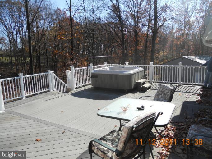 4101 Roop Road Mount Airy, MD 21771 - Photo 12 of 28 a view of a patio with table and chairs with wooden floor and fence