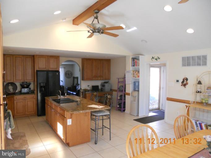 4101 Roop Road Mount Airy, MD 21771 - Photo 16 of 28 a living room with stainless steel appliances furniture a rug and a view of kitchen