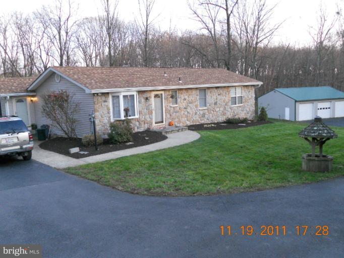4101 Roop Road Mount Airy, MD 21771 - Photo 20 of 28 a front view of a house with a garden and trees