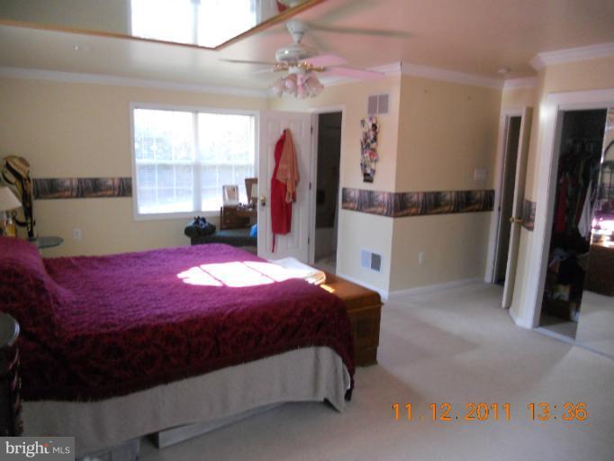 4101 Roop Road Mount Airy, MD 21771 - Photo 22 of 28 a bedroom with a bed closet and a flat tv screen