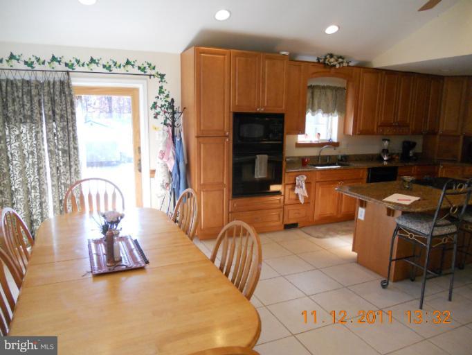 4101 Roop Road Mount Airy, MD 21771 - Photo 9 of 28 a living room with fireplace furniture and a flat screen tv