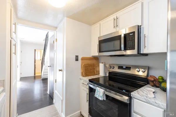 a kitchen with stainless steel appliances a stove a microwave and cabinets