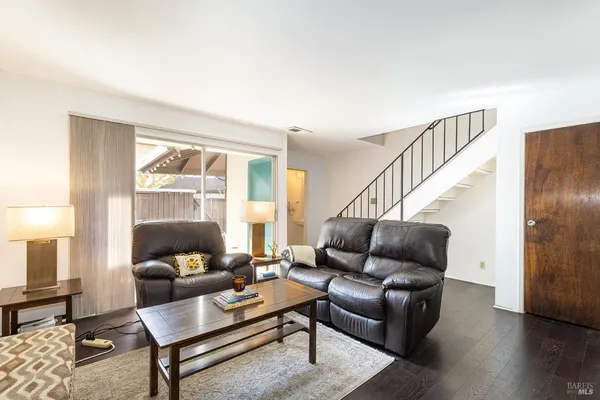 a living room with furniture and wooden floor