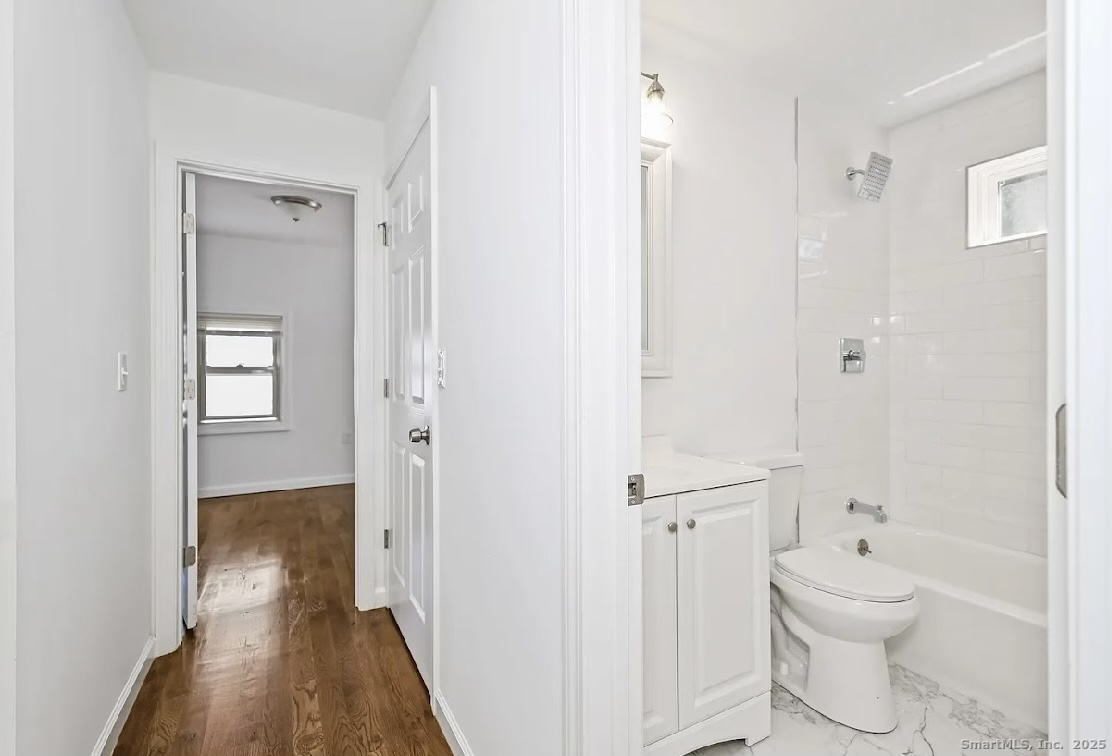 405 Ruth Street Bridgeport, CT 06606 - Photo 11 of 17 a bathroom with a toilet sink and a shower