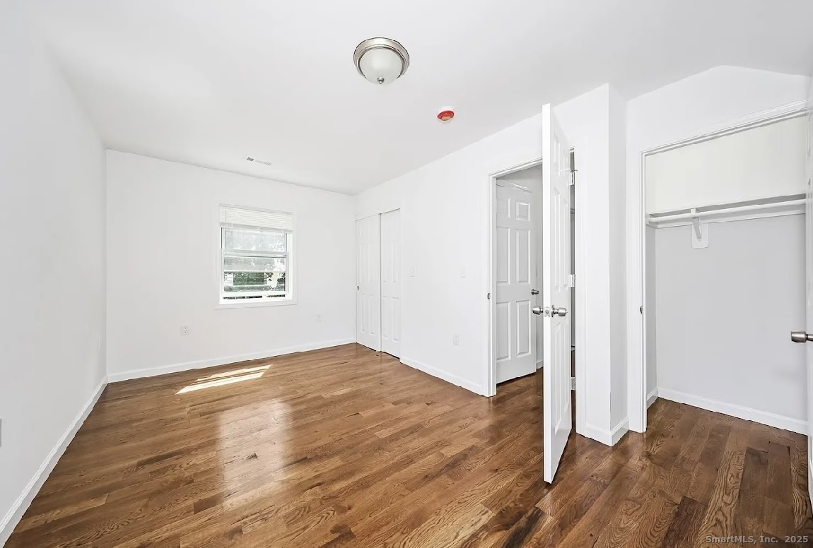 405 Ruth Street Bridgeport, CT 06606 - Photo 16 of 17 a view of an empty room with wooden floor and a window