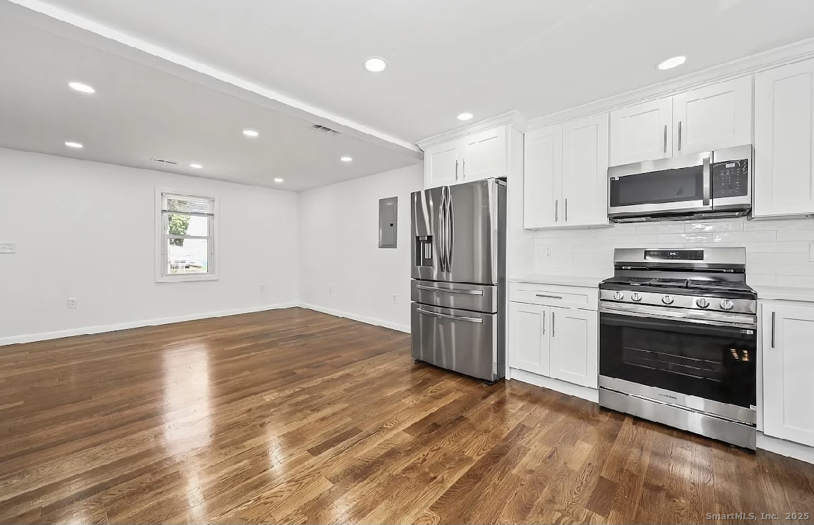 405 Ruth Street Bridgeport, CT 06606 - Photo 4 of 17 a kitchen with stainless steel appliances a refrigerator stove and microwave