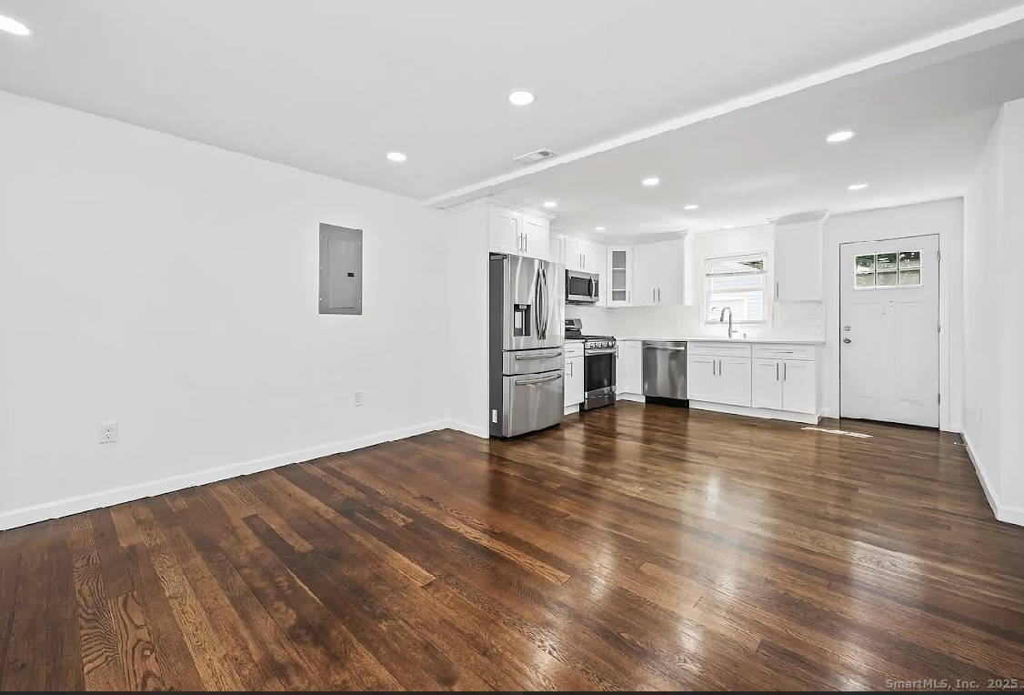 405 Ruth Street Bridgeport, CT 06606 - Photo 5 of 17 a view of kitchen with wooden floor and electronic appliances