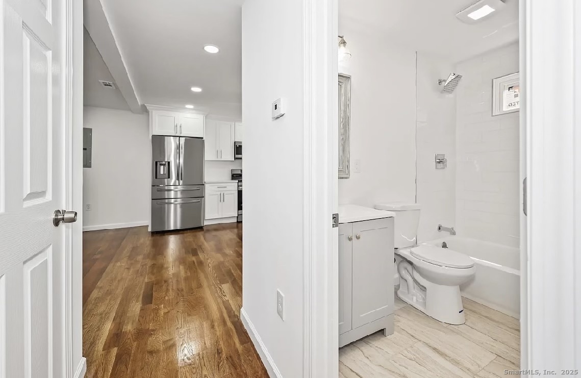 405 Ruth Street Bridgeport, CT 06606 - Photo 8 of 17 a bathroom with a sink and a toilet