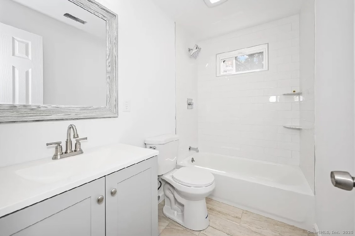 405 Ruth Street Bridgeport, CT 06606 - Photo 9 of 17 a bathroom with a sink a toilet and shower