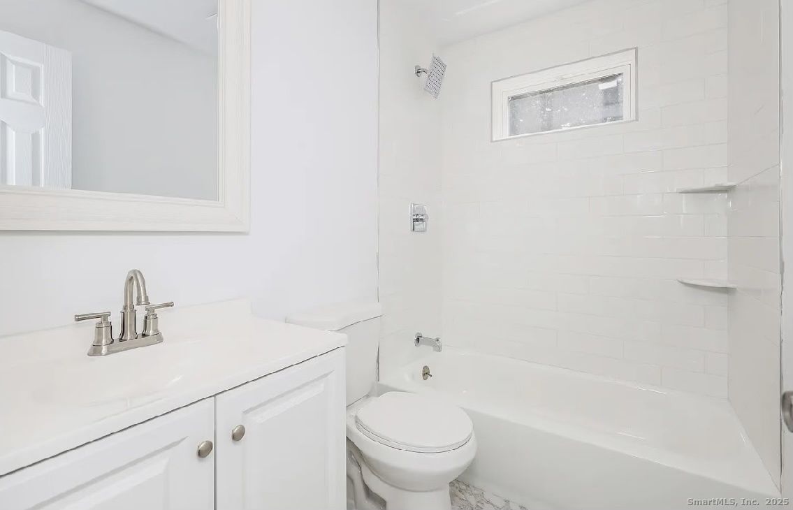405 Ruth Street Bridgeport, CT 06606 - Photo 10 of 17 a bathroom with a sink a toilet and shower