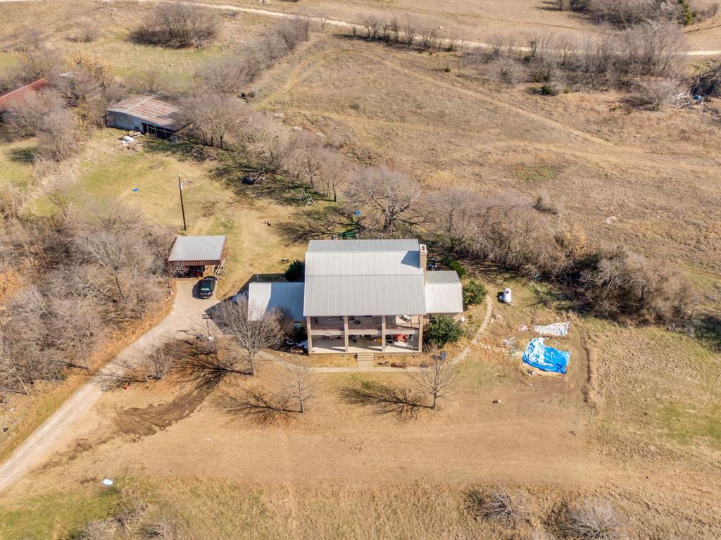 10400 Baucum Road Midlothian, TX 76065 - Photo 2 of 17 an aerial view of a house with a yard and mountain view in back