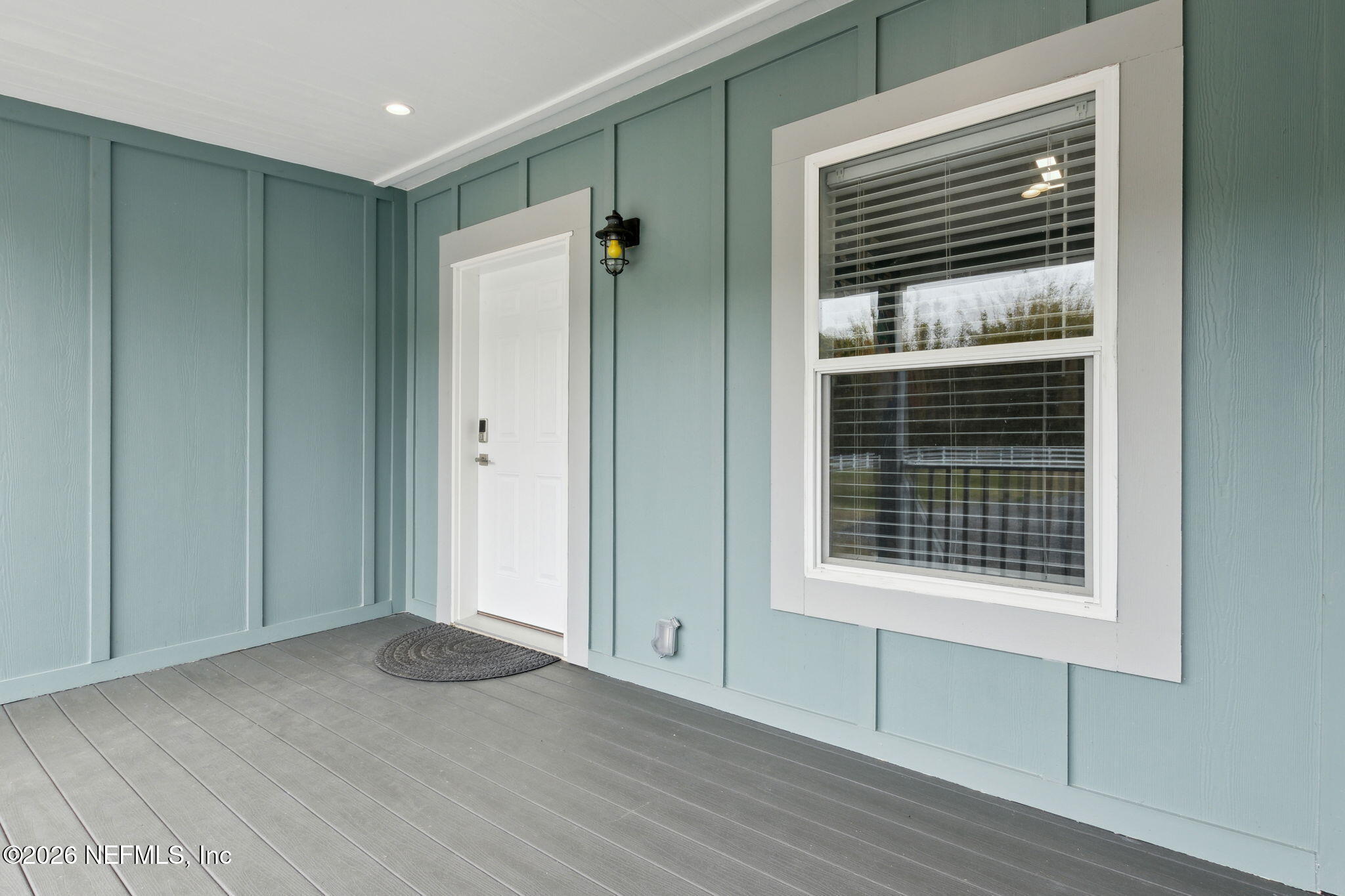 208 Lake George Point Drive Georgetown, FL 32139 - Photo 4 of 76 a view of an empty room with wooden floor and a window