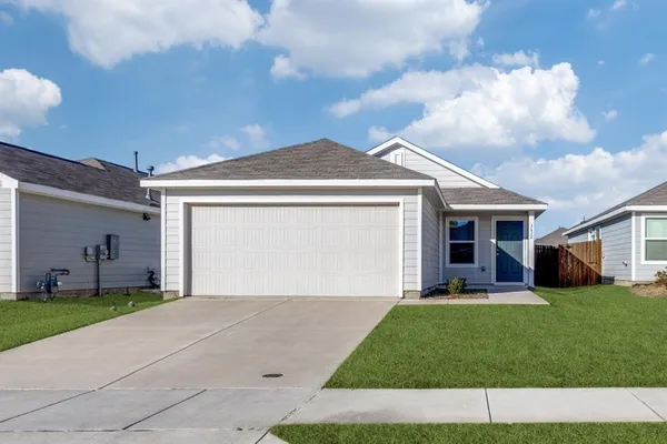a front view of a house with a garden and yard