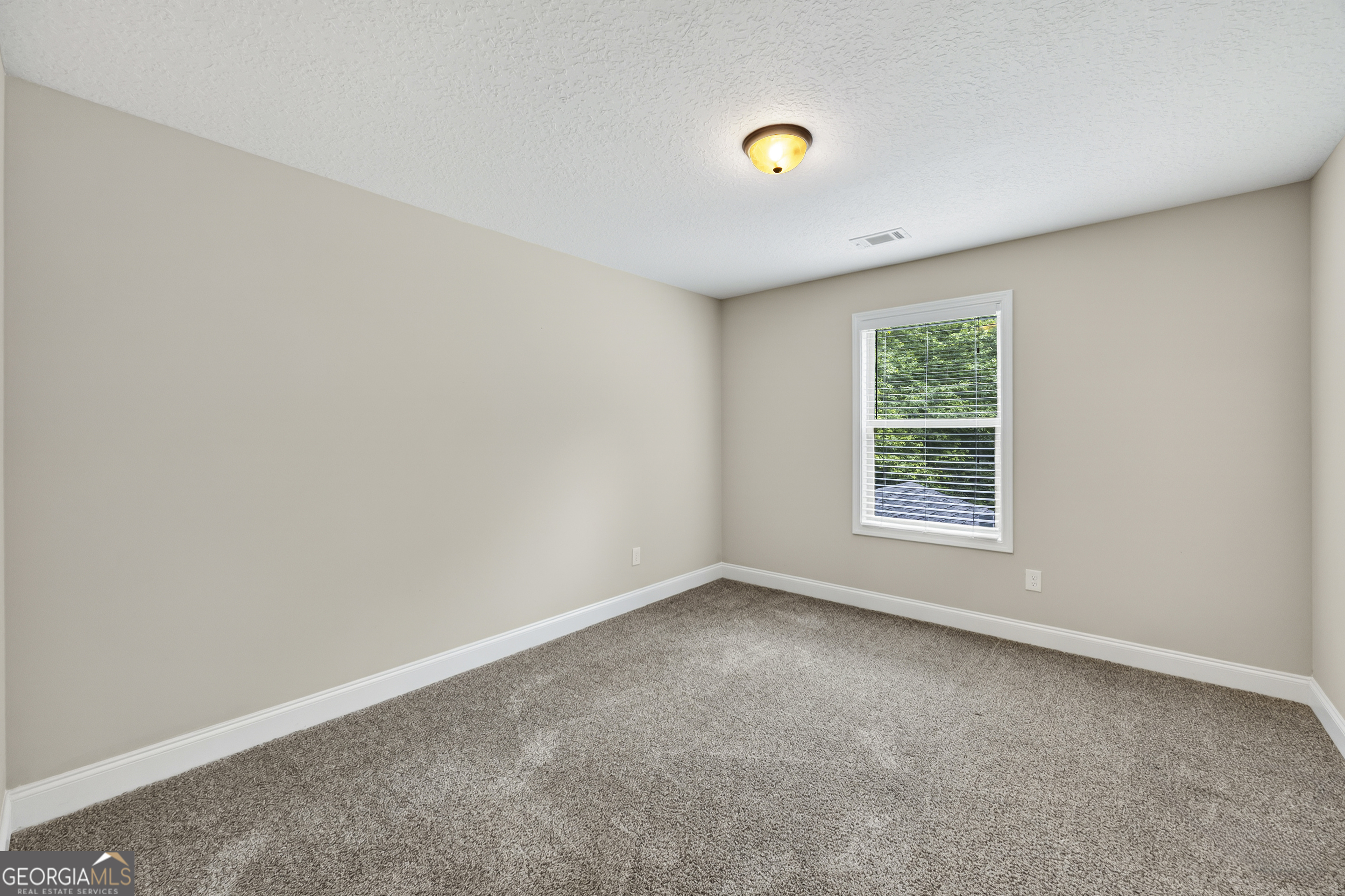 717 Oconee Lane Commerce, GA 30529 - Photo 40 of 57 an empty room with a window