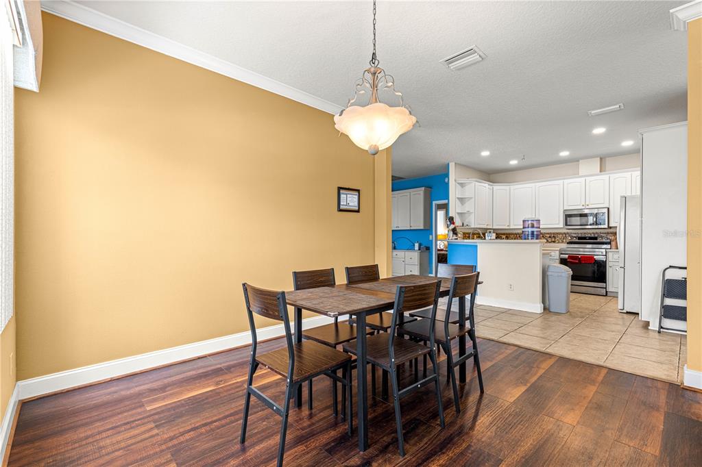 6551 Southeast 11th Loop Ocala, FL 34472 - Photo 12 of 46 a view of a dining room with furniture and wooden floor