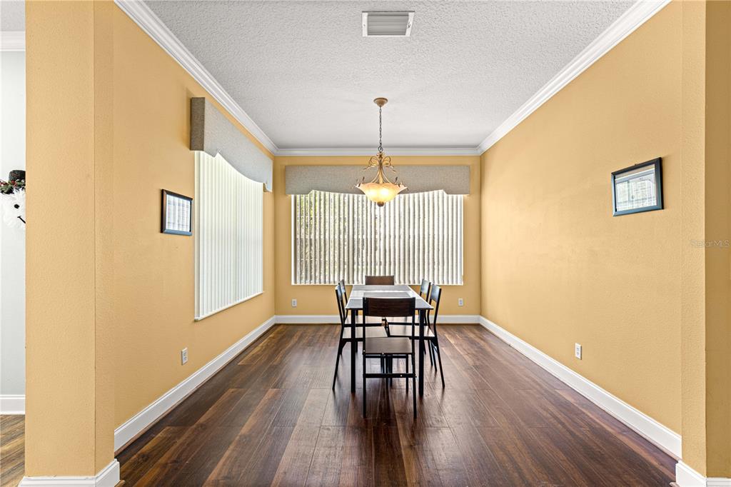 6551 Southeast 11th Loop Ocala, FL 34472 - Photo 13 of 46 a dining room with furniture window and wooden floor