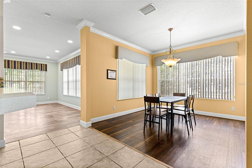 6551 Southeast 11th Loop Ocala, FL 34472 - Photo 14 of 46 a view of a dining room with furniture window and wooden floor