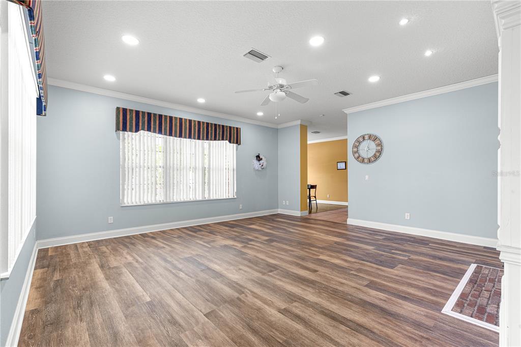 6551 Southeast 11th Loop Ocala, FL 34472 - Photo 15 of 46 a view of an empty room with wooden floor and a window