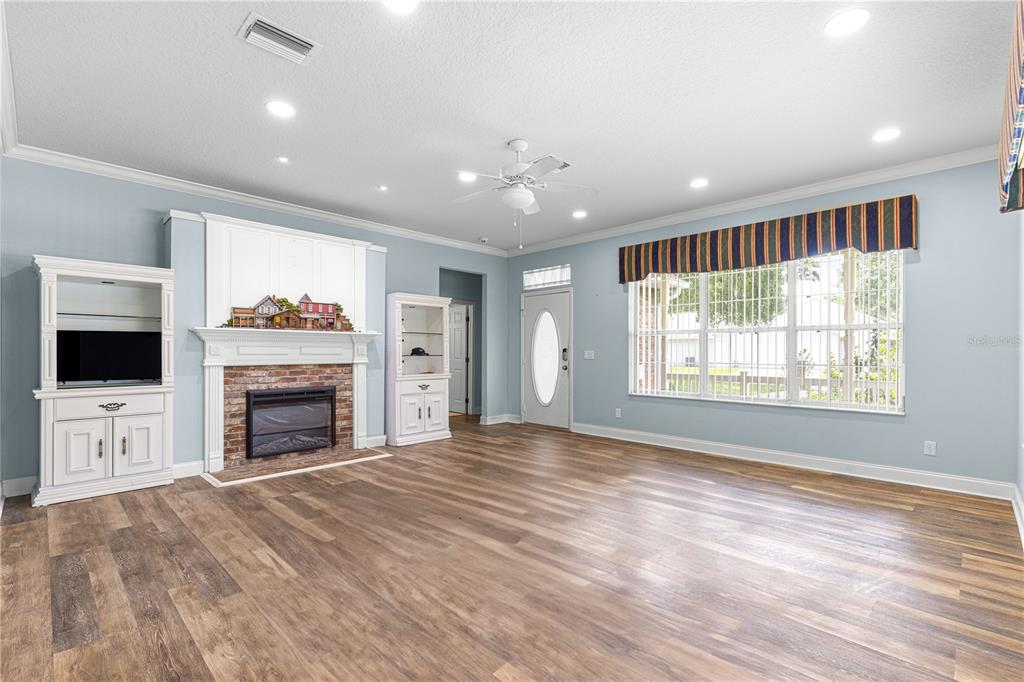 6551 Southeast 11th Loop Ocala, FL 34472 - Photo 17 of 46 a view of an empty room with a fireplace and a window