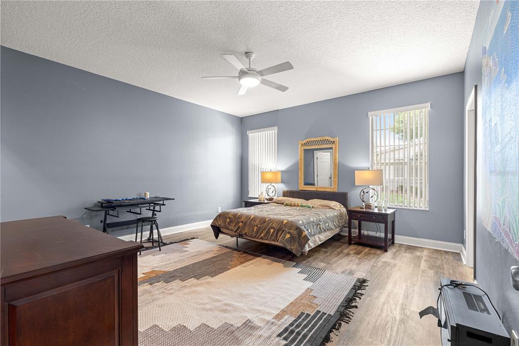 6551 Southeast 11th Loop Ocala, FL 34472 - Photo 18 of 46 a bedroom with a bed and wooden floor