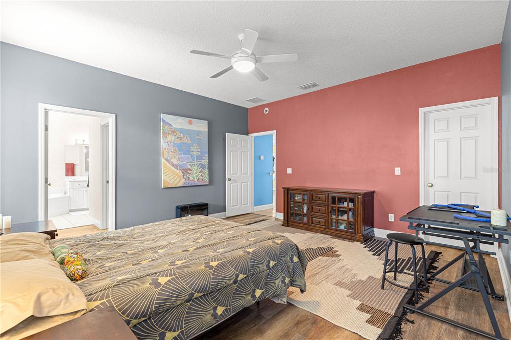 6551 Southeast 11th Loop Ocala, FL 34472 - Photo 20 of 46 a bedroom with a bed and a chandelier