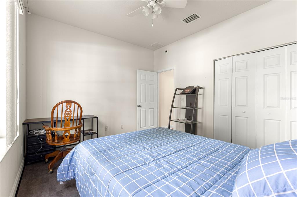 6551 Southeast 11th Loop Ocala, FL 34472 - Photo 26 of 46 a bedroom with a bed and a chandelier
