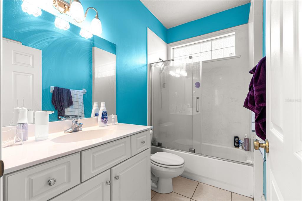 6551 Southeast 11th Loop Ocala, FL 34472 - Photo 29 of 46 a bathroom with a sink a toilet and shower