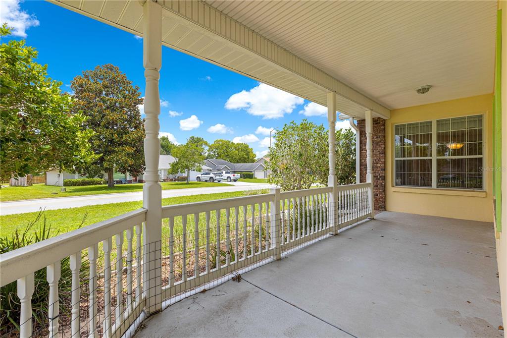6551 Southeast 11th Loop Ocala, FL 34472 - Photo 3 of 46 a view of balcony with floor to ceiling windows and yard