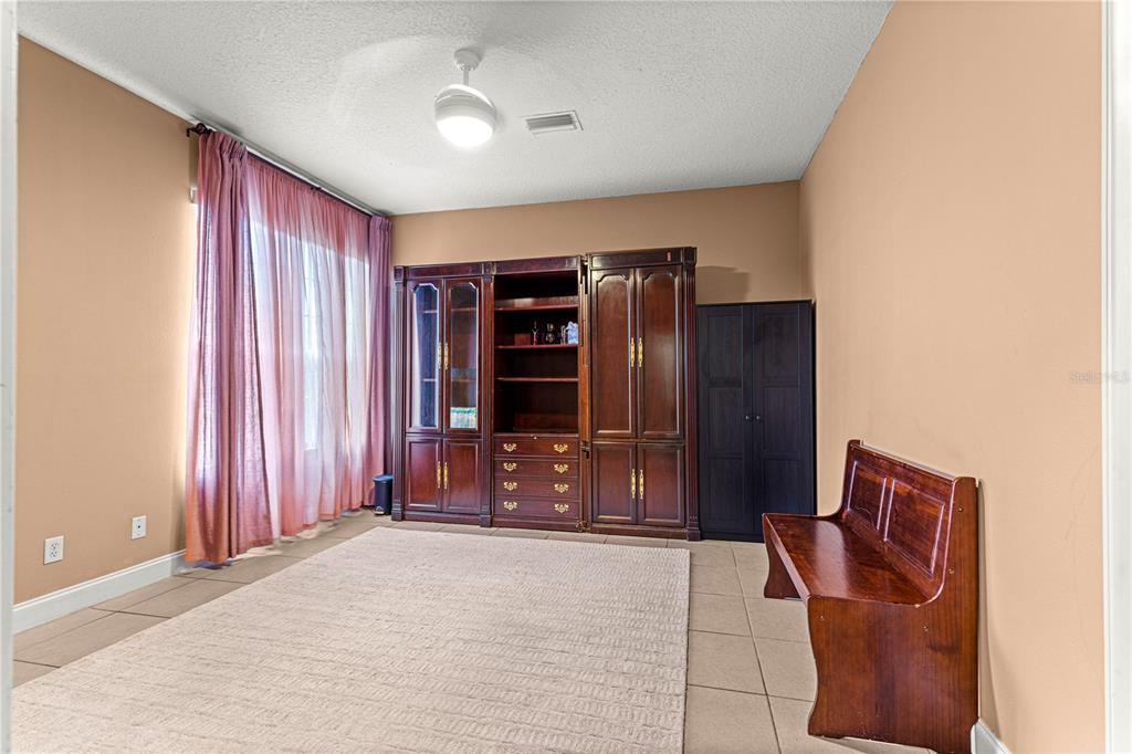 6551 Southeast 11th Loop Ocala, FL 34472 - Photo 31 of 46 a living room with furniture windows and a flat screen tv