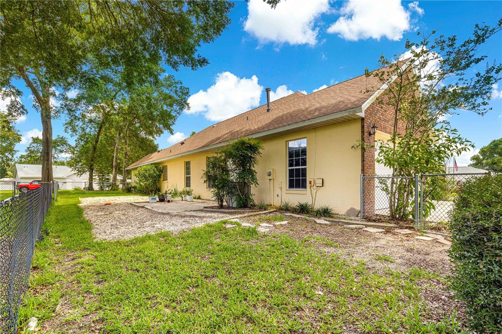 6551 Southeast 11th Loop Ocala, FL 34472 - Photo 36 of 46 a view of a house with yard and tree s