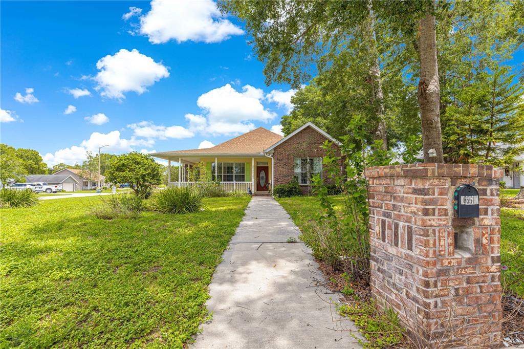 6551 Southeast 11th Loop Ocala, FL 34472 - Photo 39 of 46 a view of a brick house with a yard
