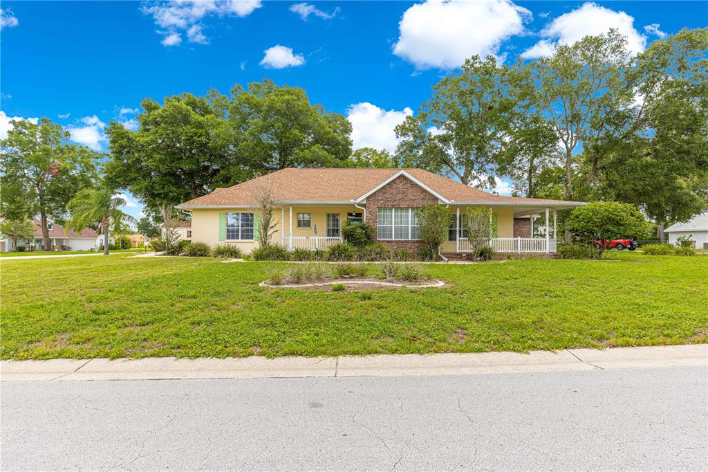6551 Southeast 11th Loop Ocala, FL 34472 - Photo 41 of 46 a front view of a house with a yard