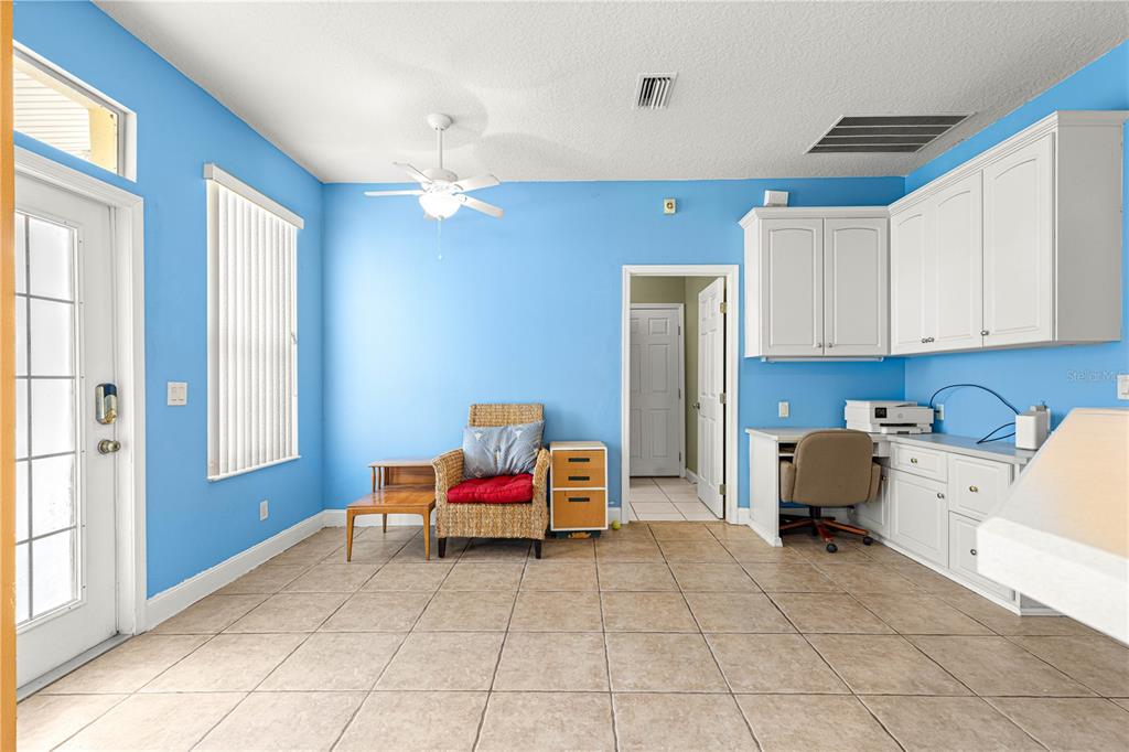 6551 Southeast 11th Loop Ocala, FL 34472 - Photo 7 of 46 a bedroom with furniture and a chandelier